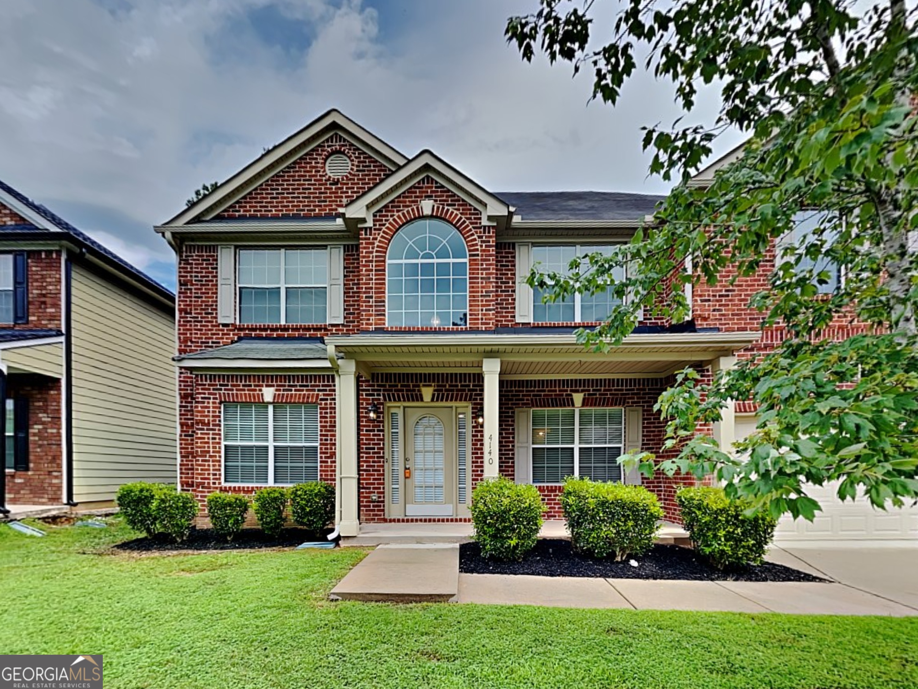 a front view of a house with a yard