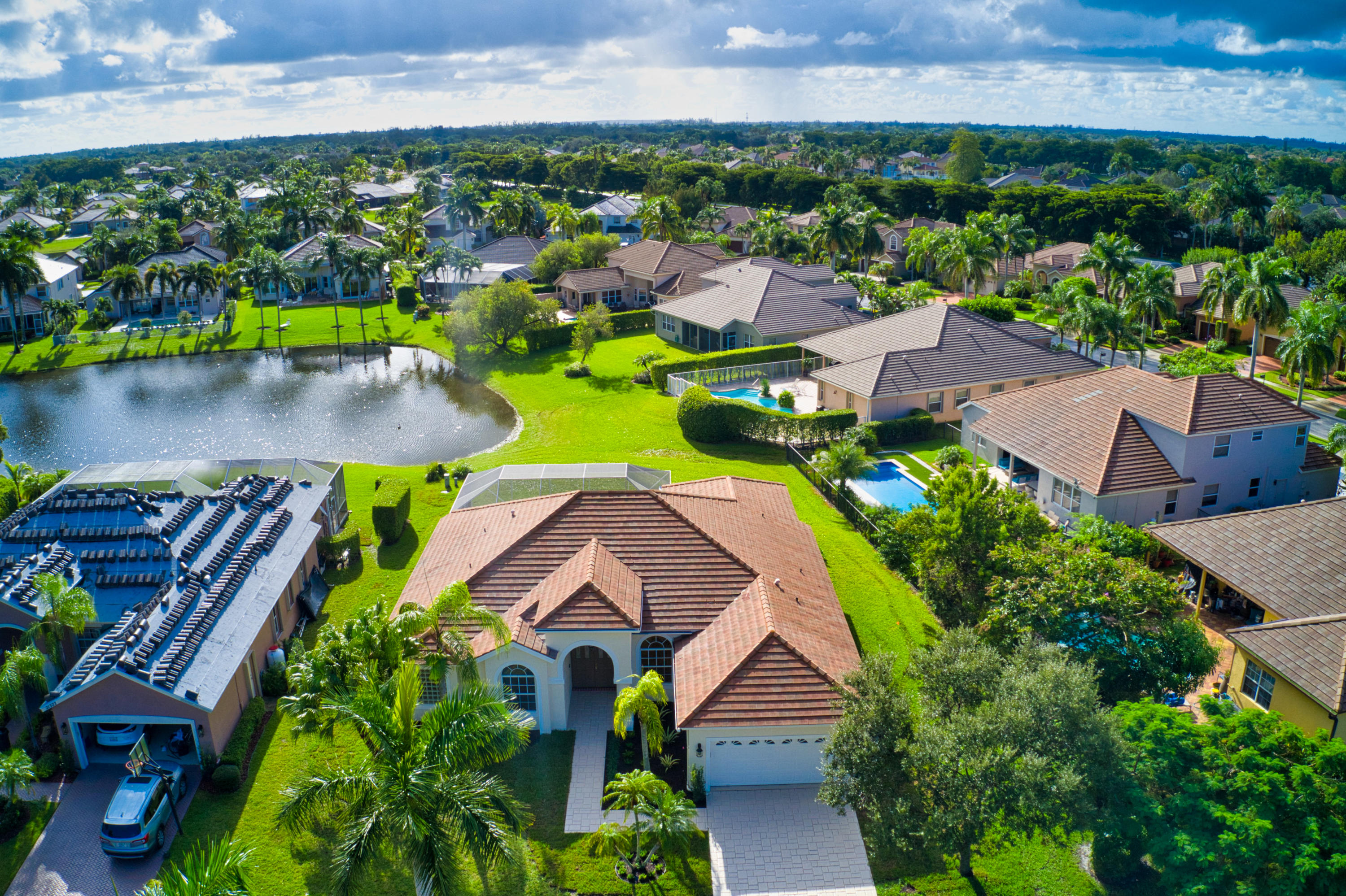 an aerial view of residential houses with outdoor space and swimming pool