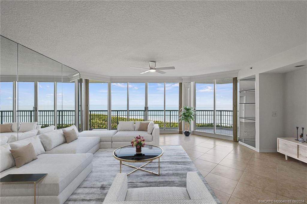 a living room with furniture and a floor to ceiling window