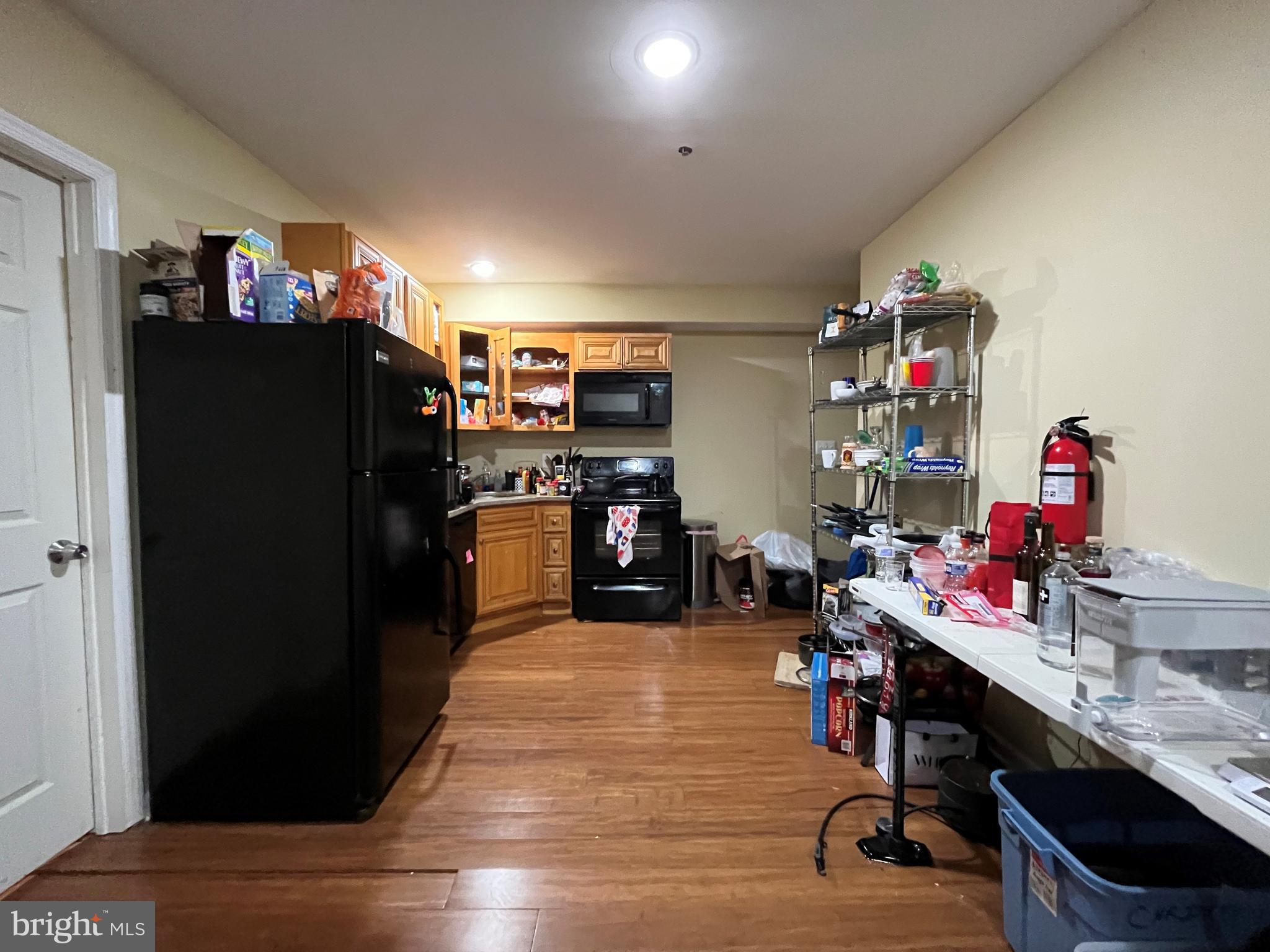 a kitchen with a refrigerator and a table