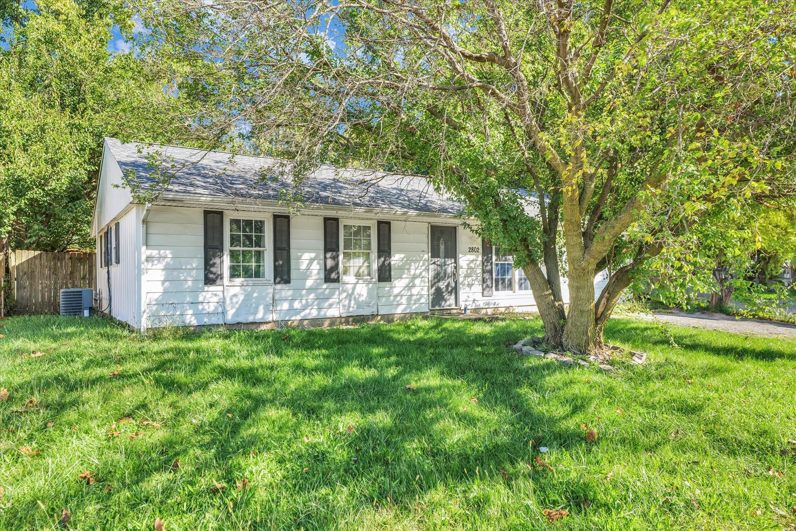 a front view of a house with yard patio and green space