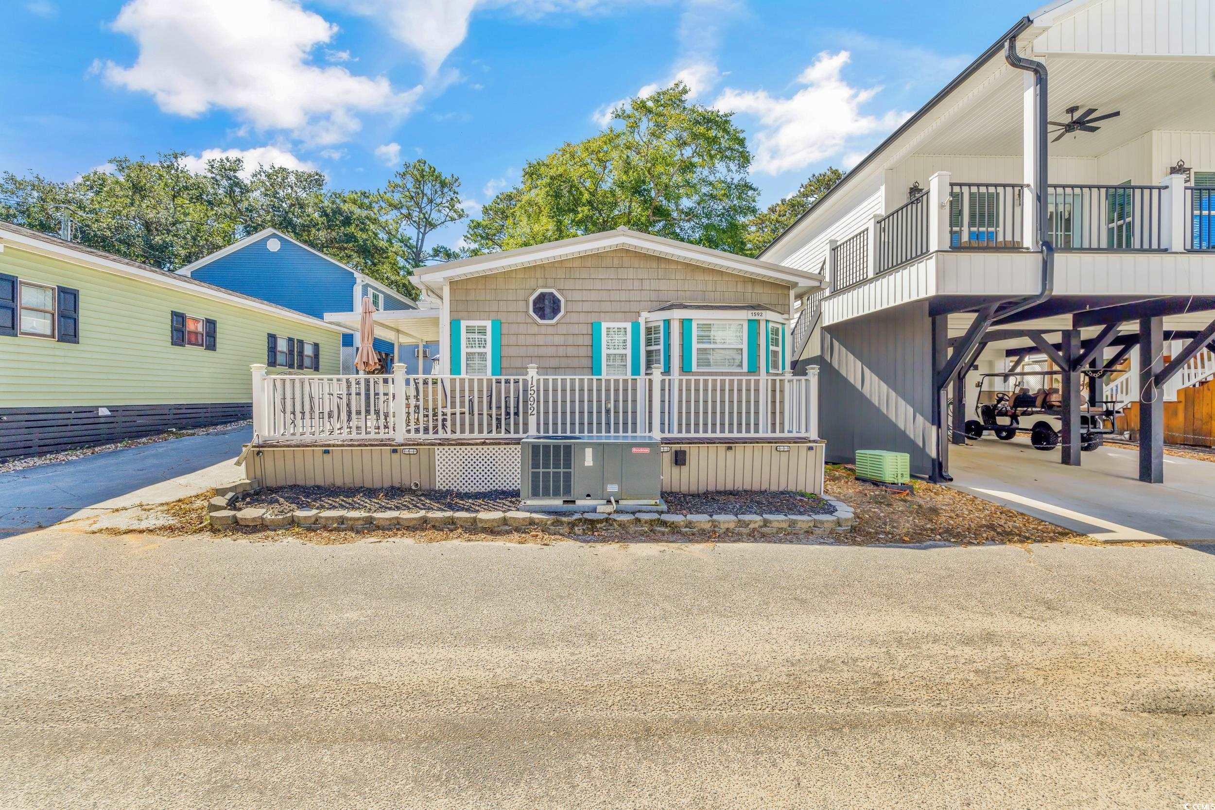 View of front of home featuring a deck and central