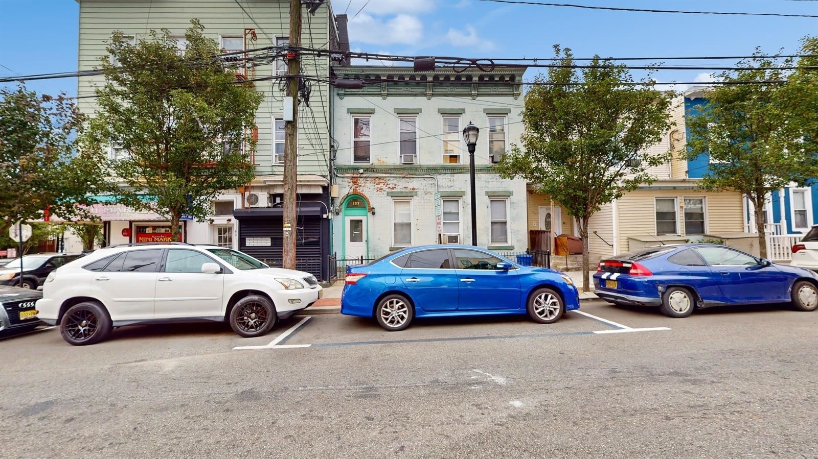 front of a house with car parked