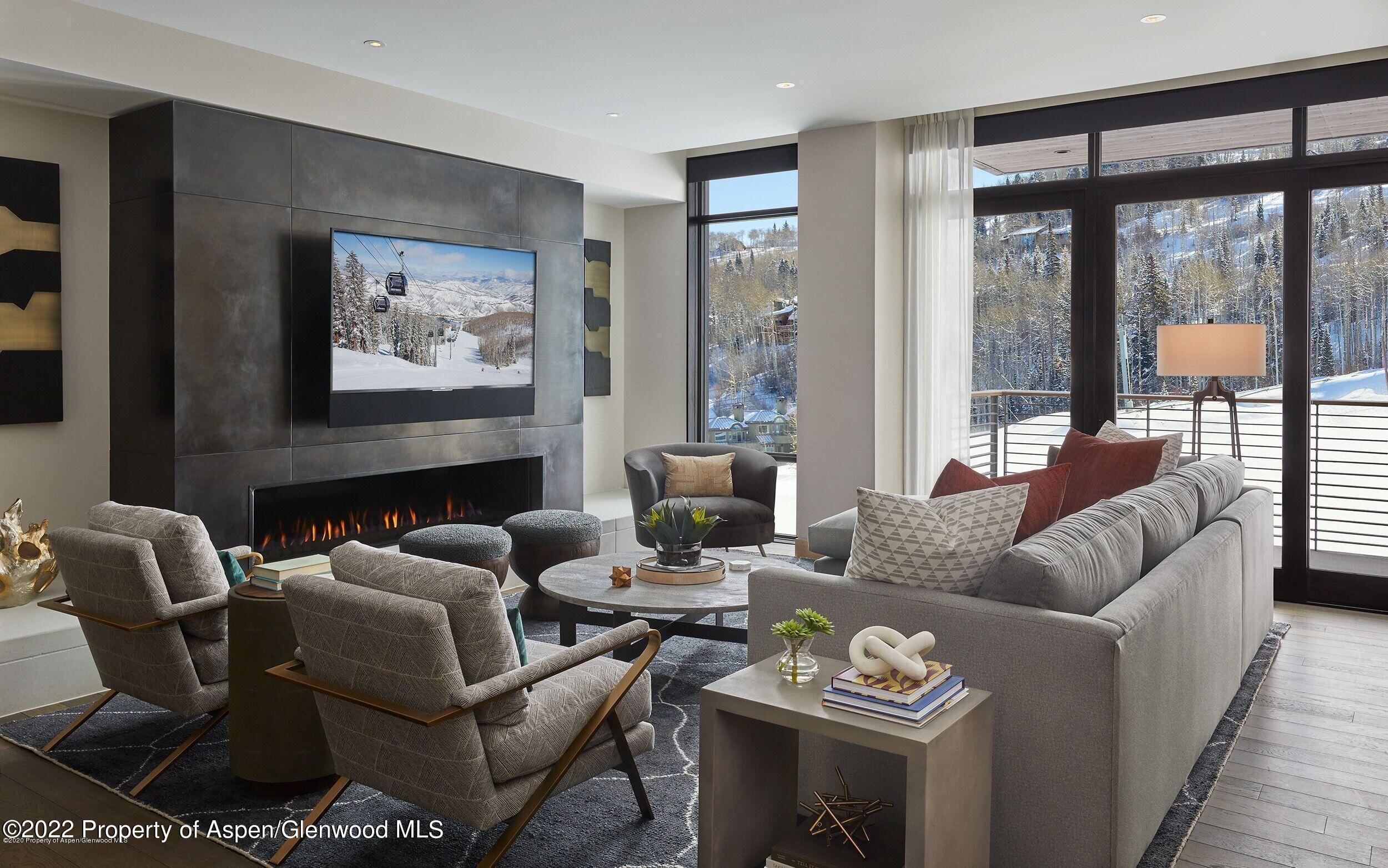 a living room with furniture a large window and a flat screen tv