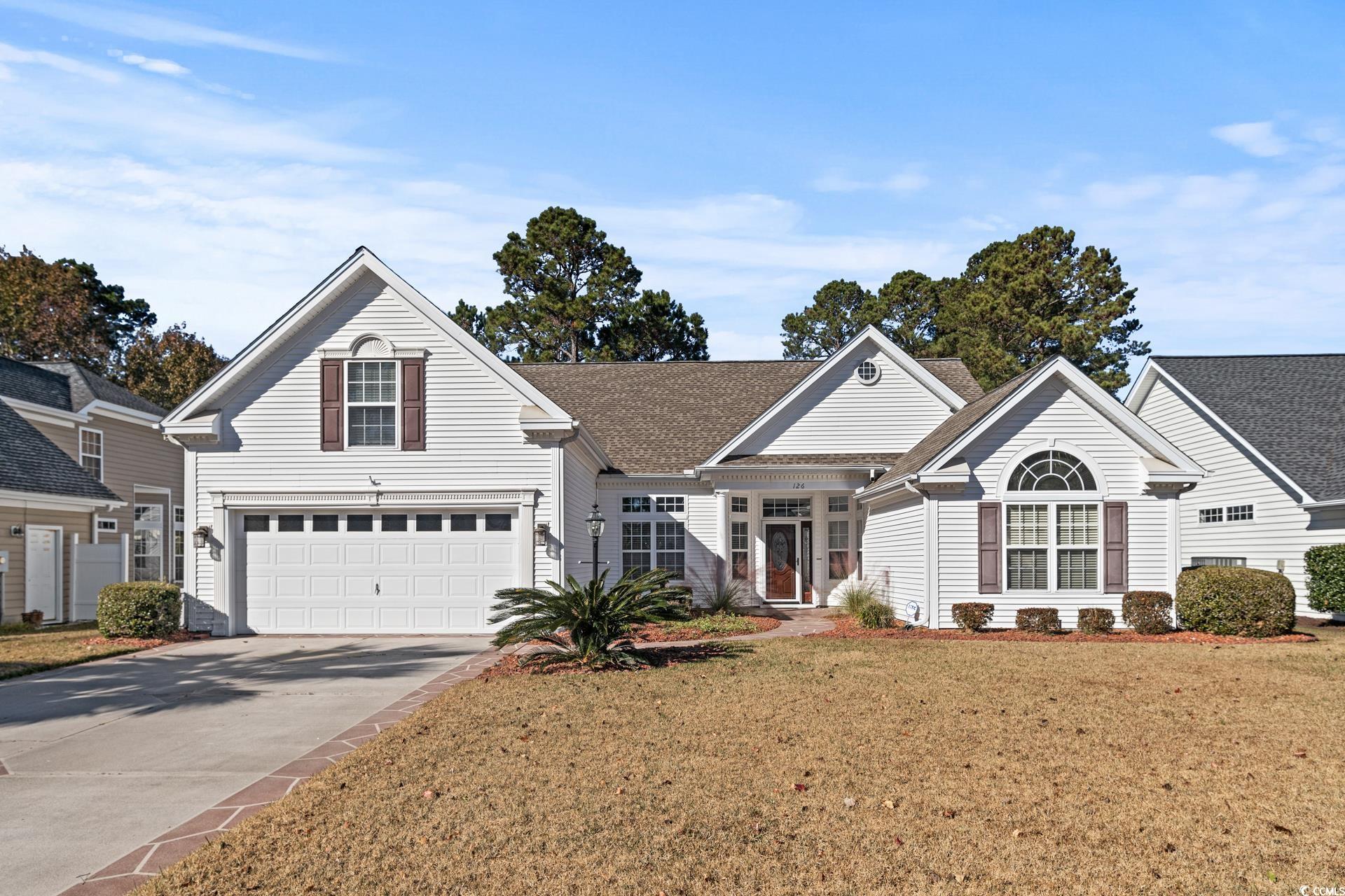 Front of property featuring a garage and a front l