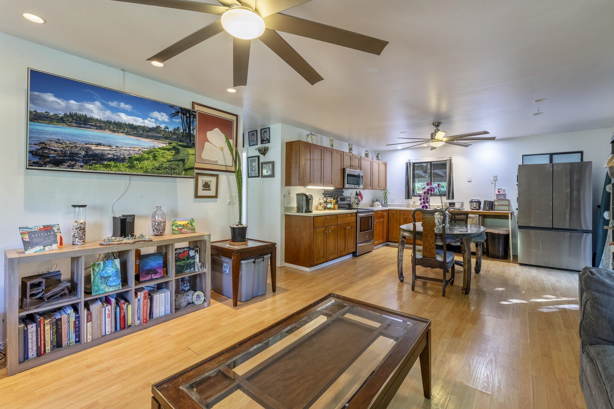 a living room with lots of furniture and kitchen view