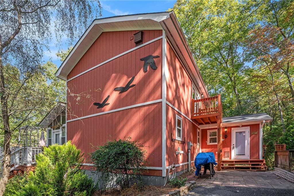 a backyard of a house with barbeque oven table and chairs