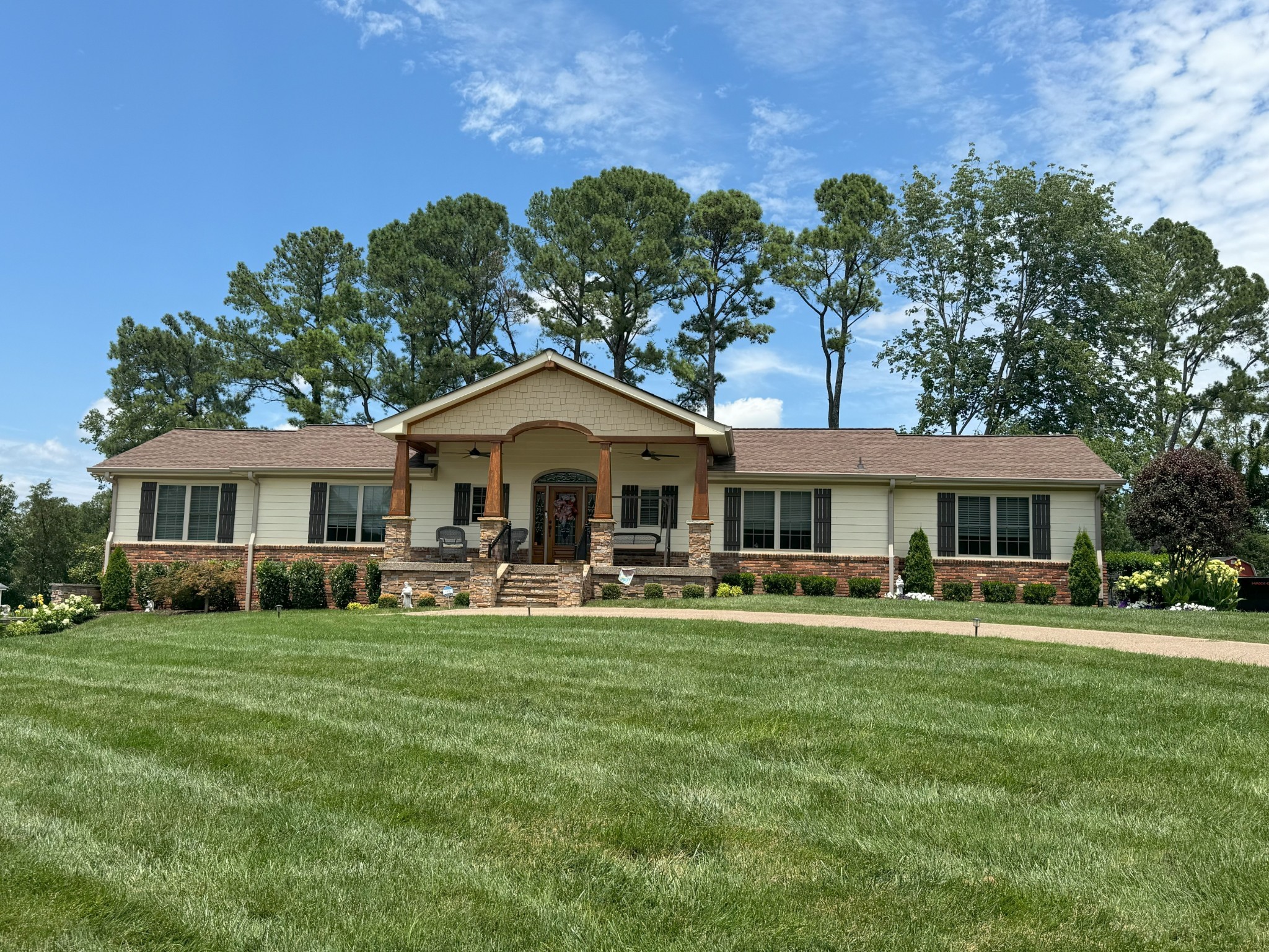 a front view of a house with a garden