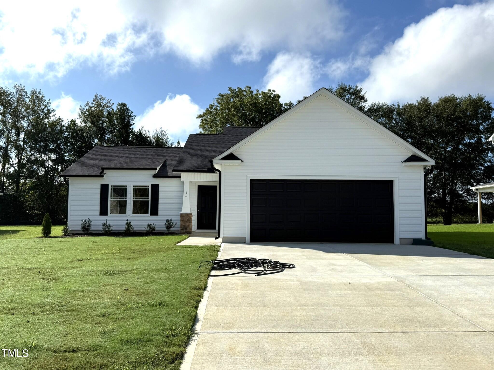 a front view of house with yard and trees