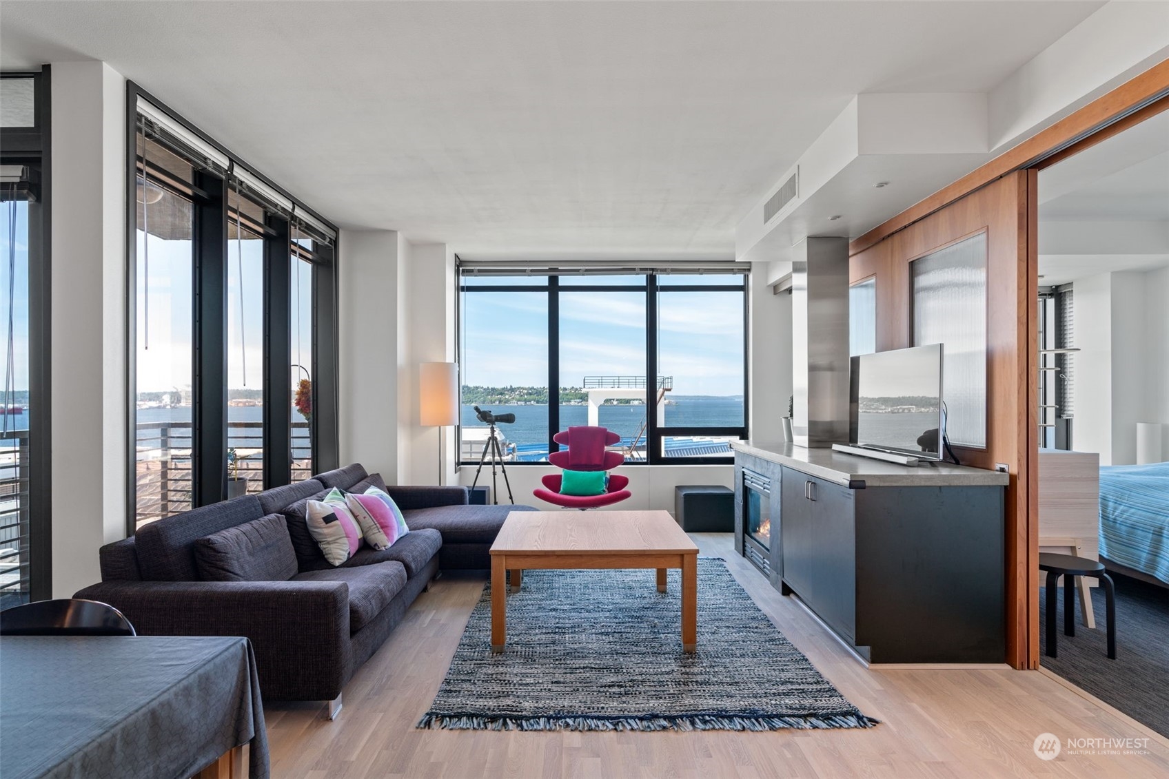 a living room with furniture and large windows