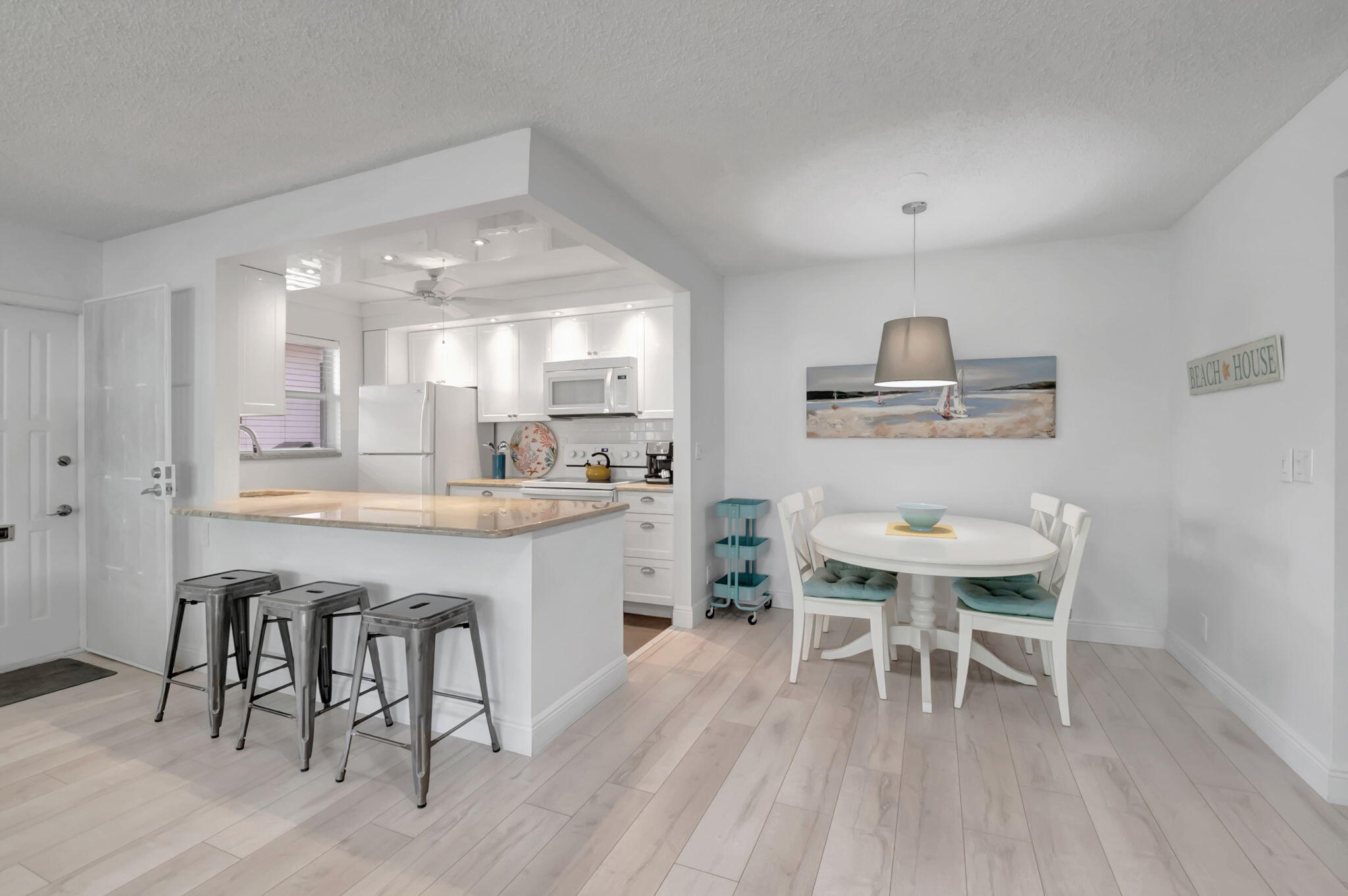 a kitchen with a table and chairs in it