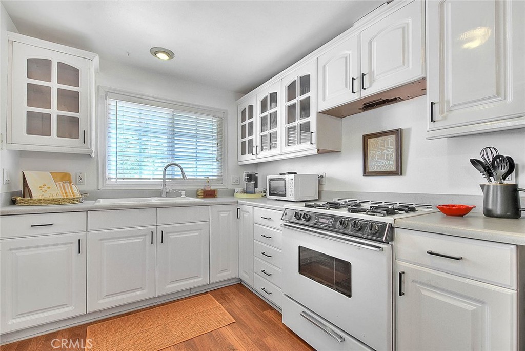 a kitchen with granite countertop cabinets stainless steel appliances and a sink