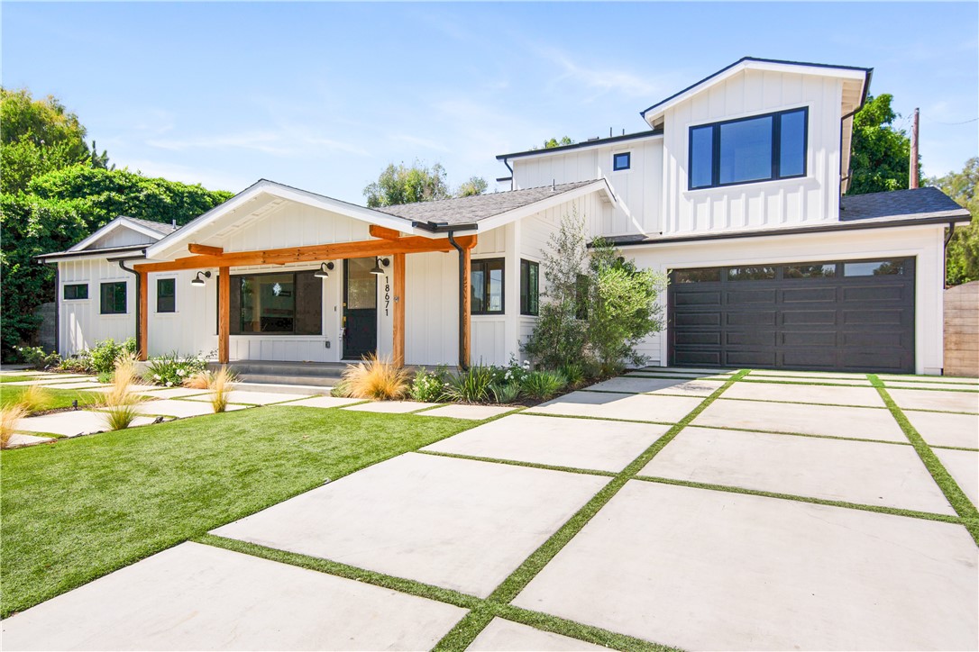 a front view of a house with a garden