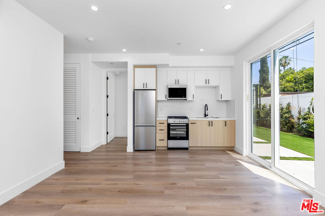 a view of kitchen with stainless steel appliances refrigerator oven and stove