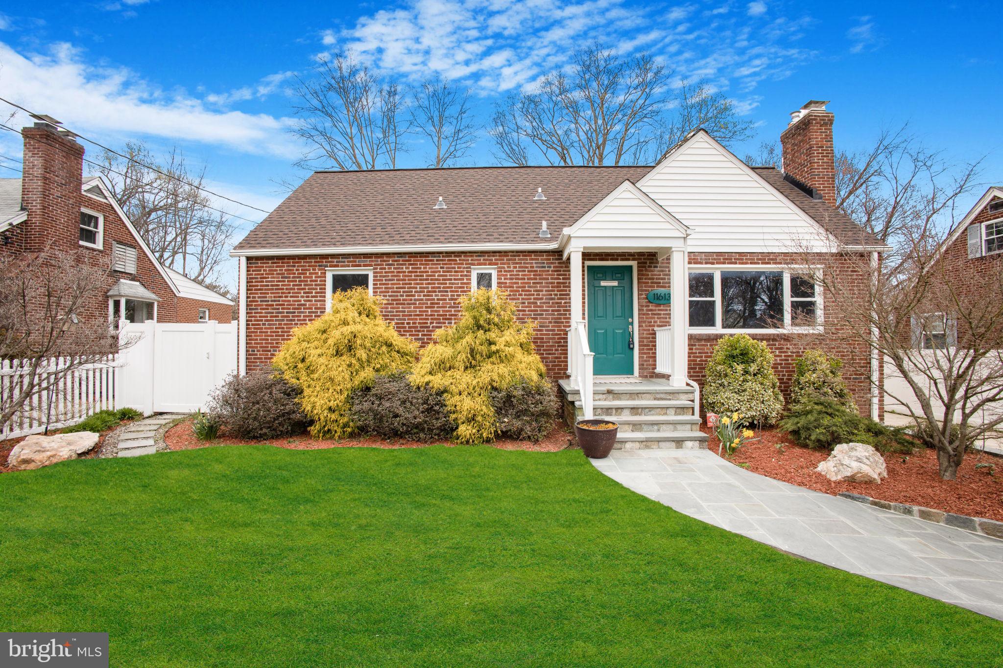 a view of a house with garden and yard