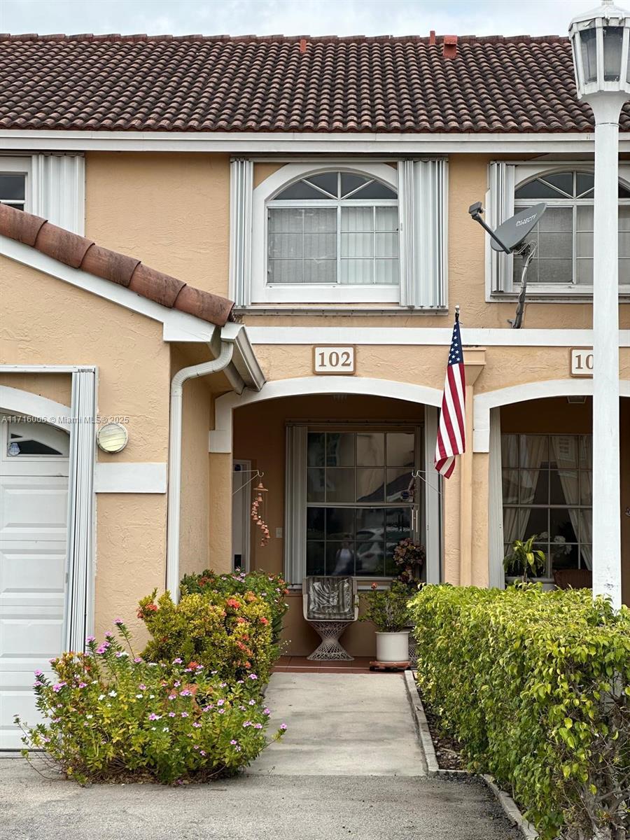 a front view of a house with garden