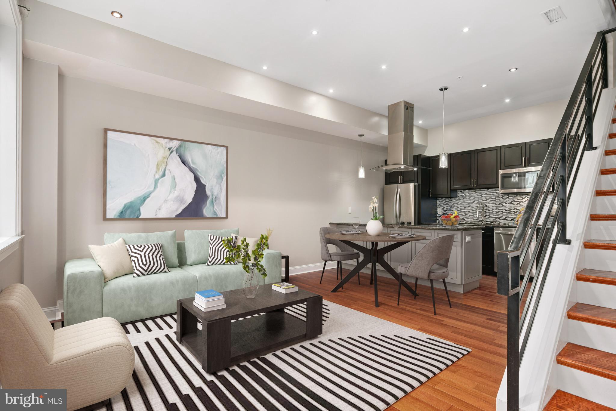 a living room with furniture and a wooden floor