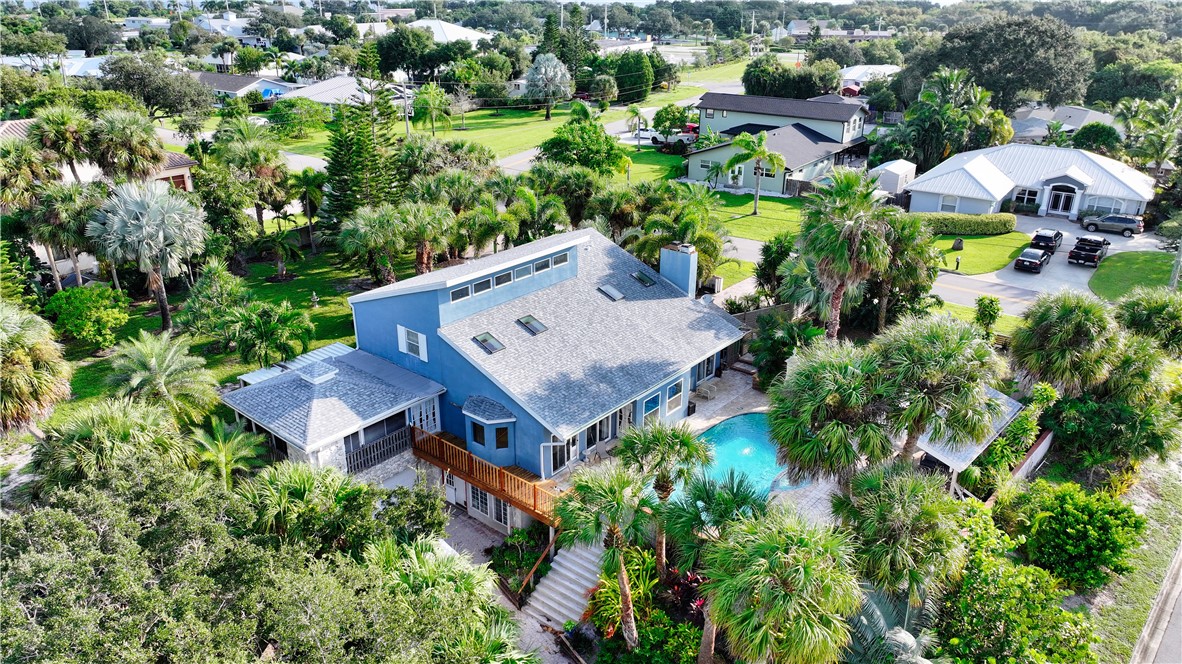 an aerial view of a house with a yard and garden