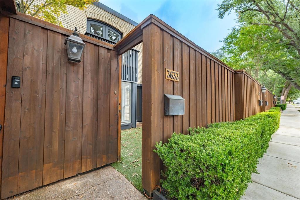 a view of a house with a wooden fence