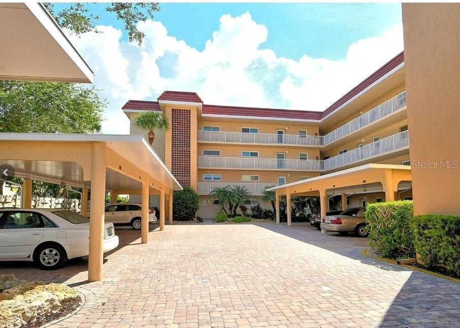 a front view of a building with parking