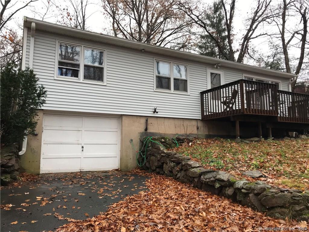 a front view of a house with a tree