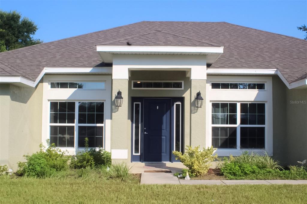 a front view of a house with a yard