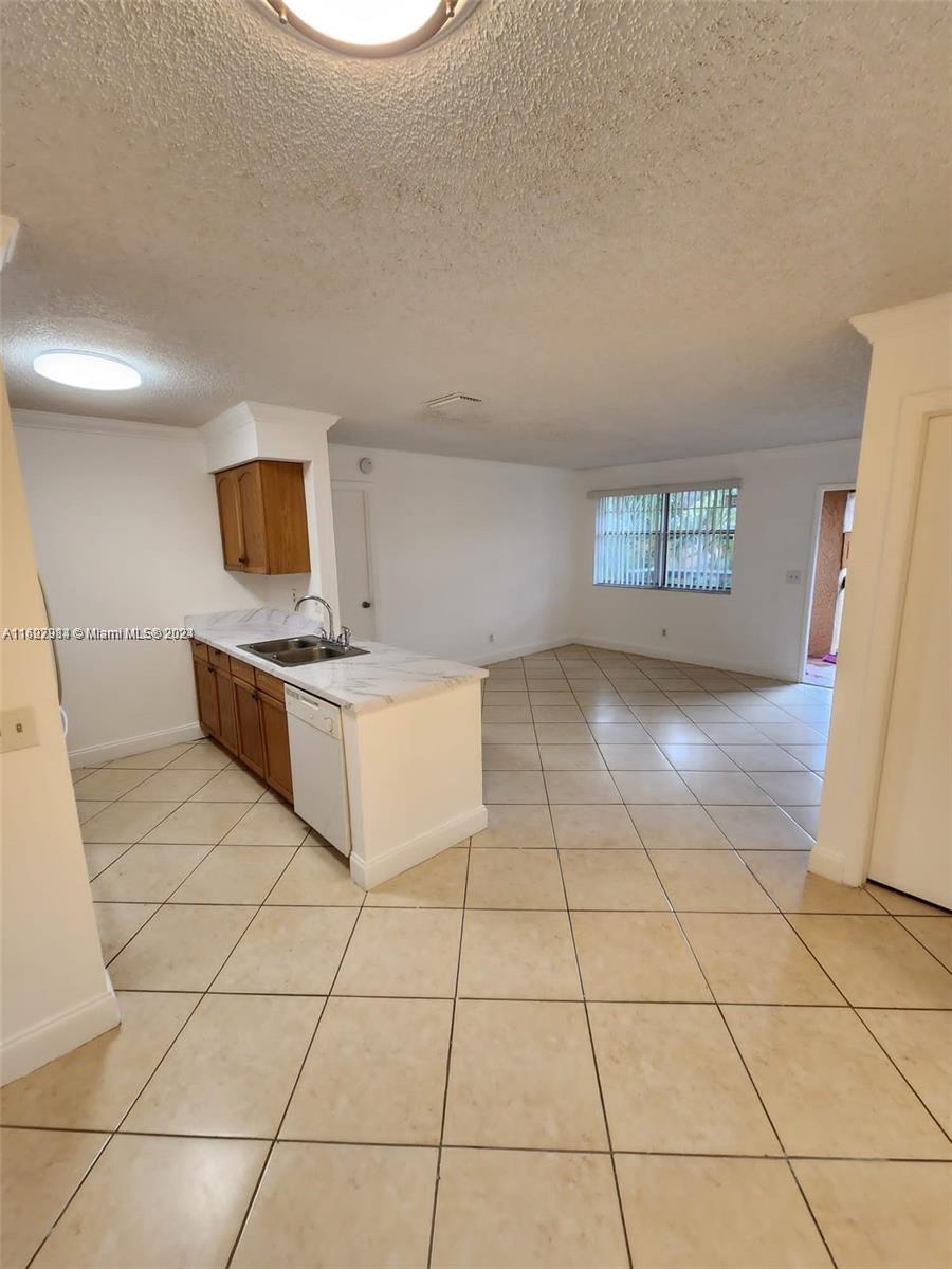 a kitchen with a sink a stove a microwave and cabinets