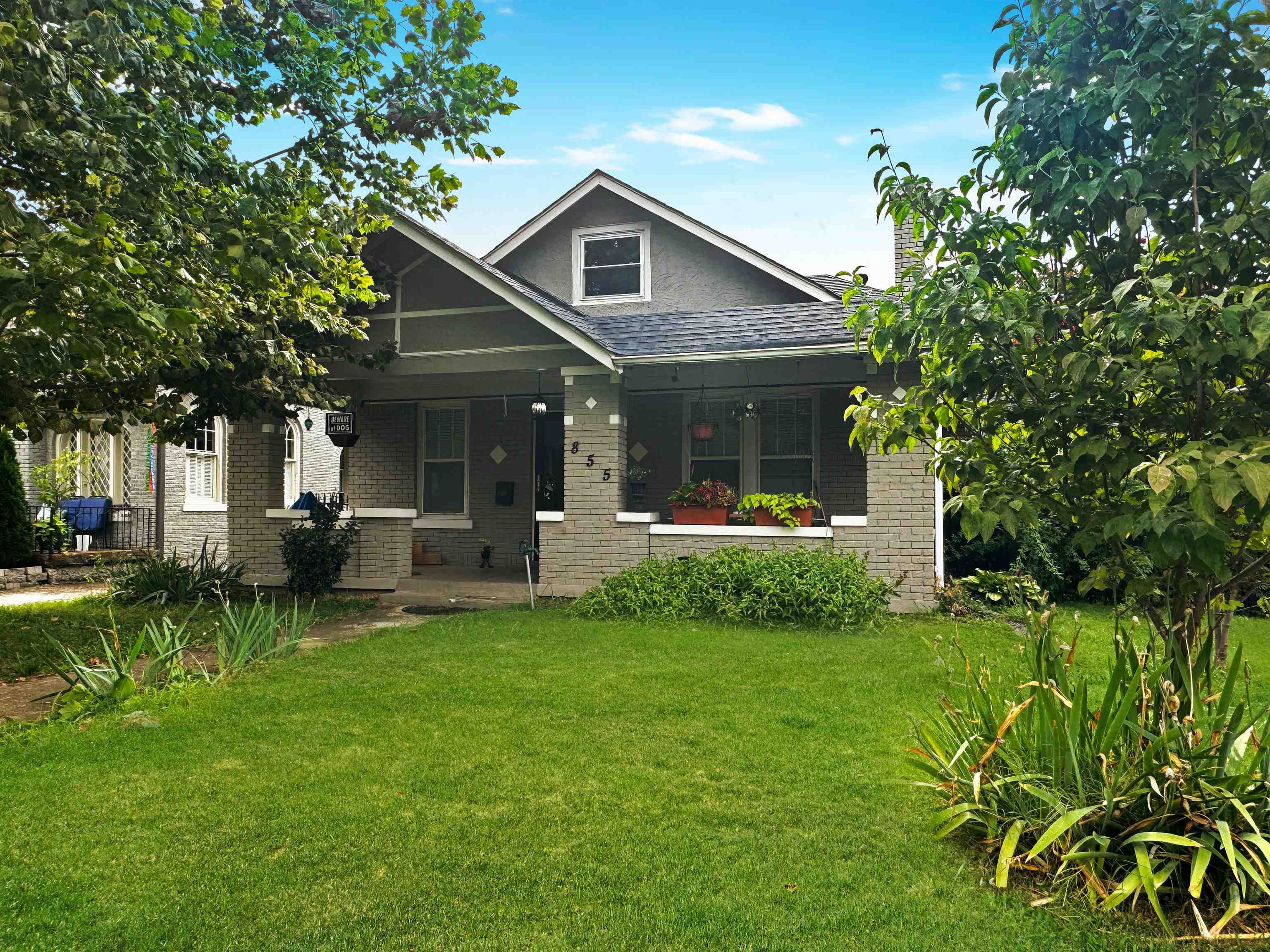 a front view of house with yard and green space