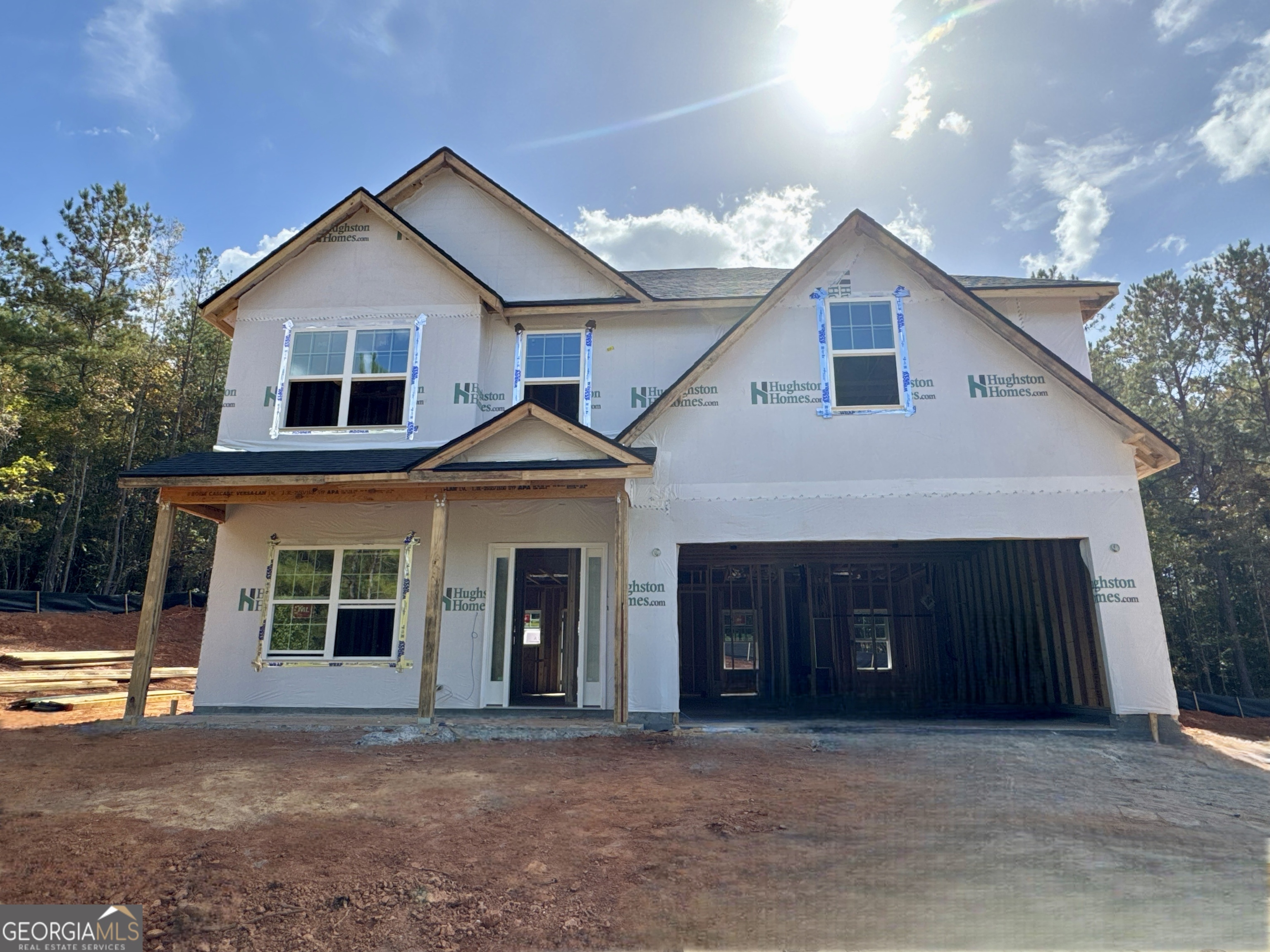 a front view of a house with a garage and balcony