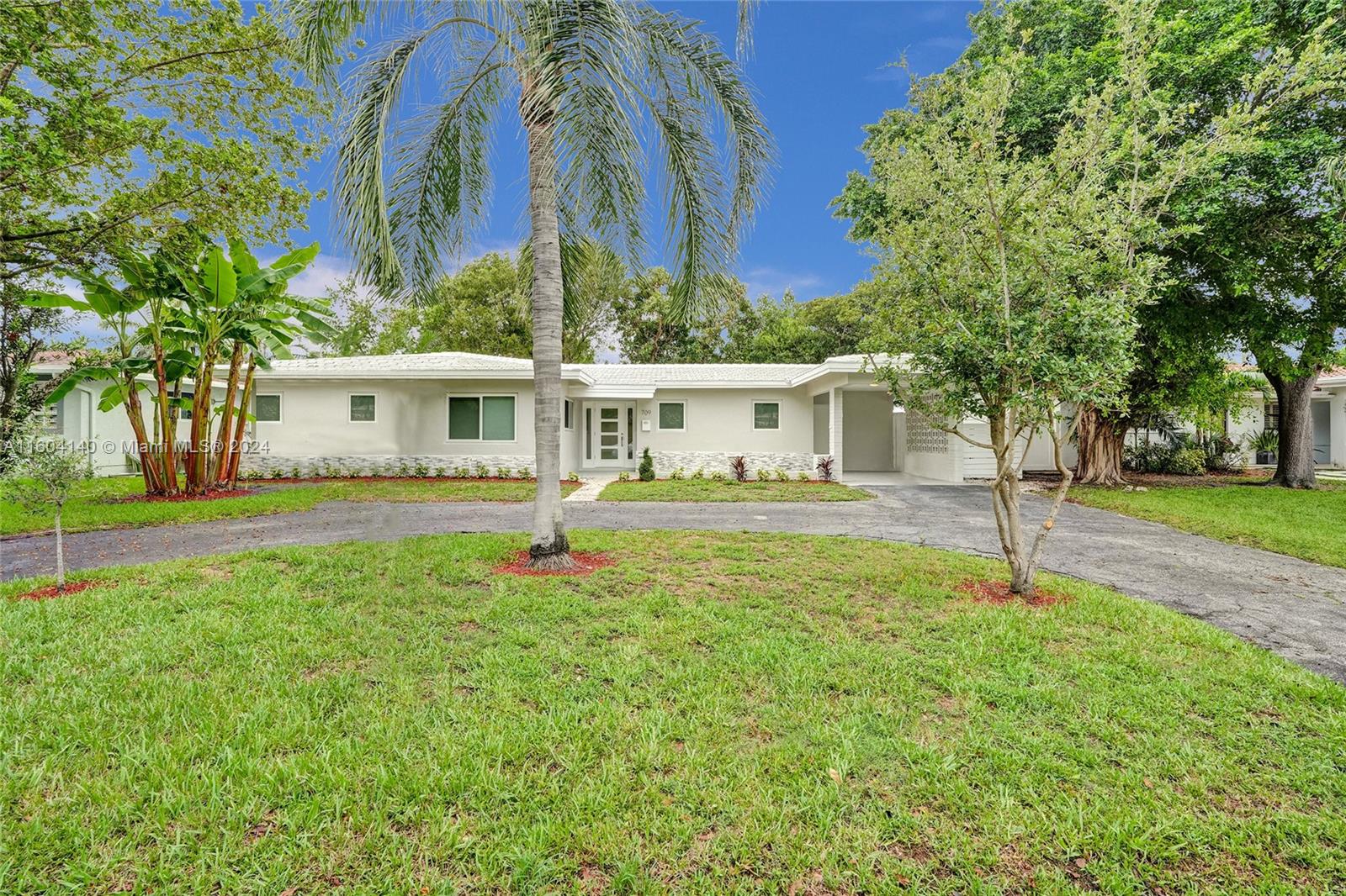 a house that has a tree in front of the house