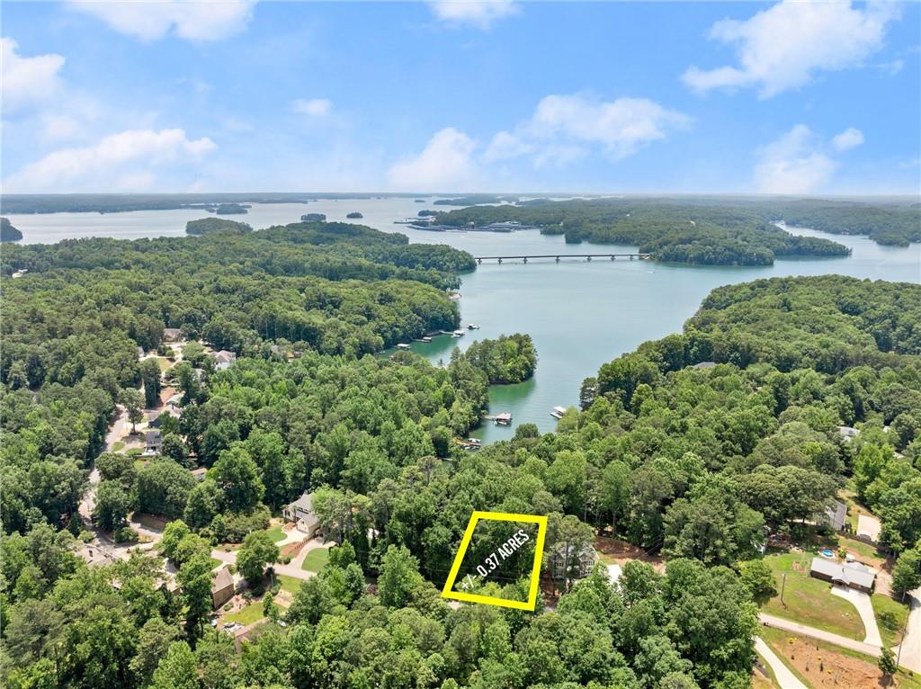 an aerial view of a house with a yard and lake view