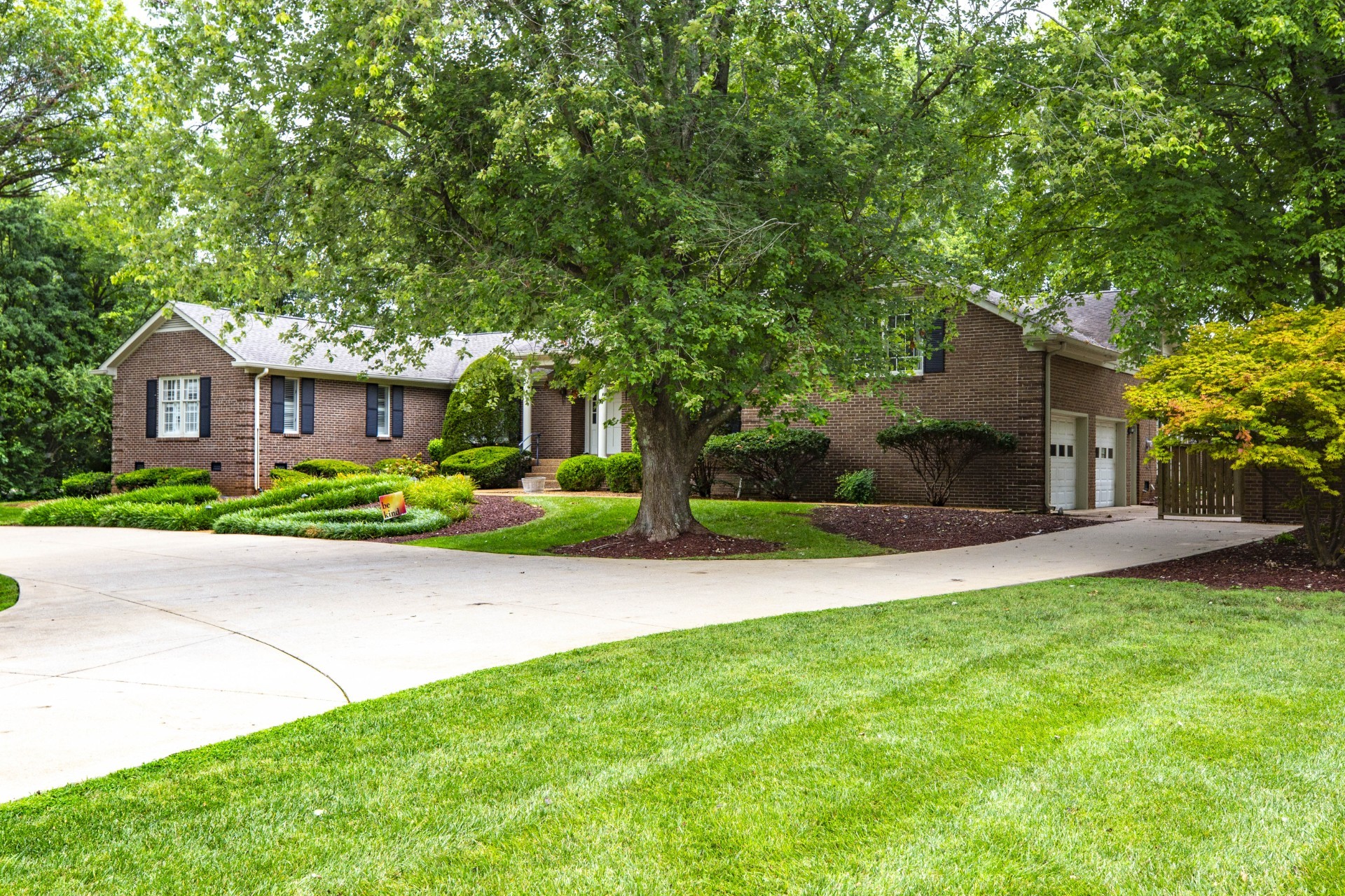 a front view of a house with a yard and a garage