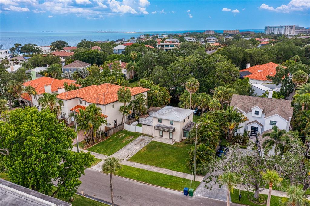 an aerial view of a house with a garden and lake view