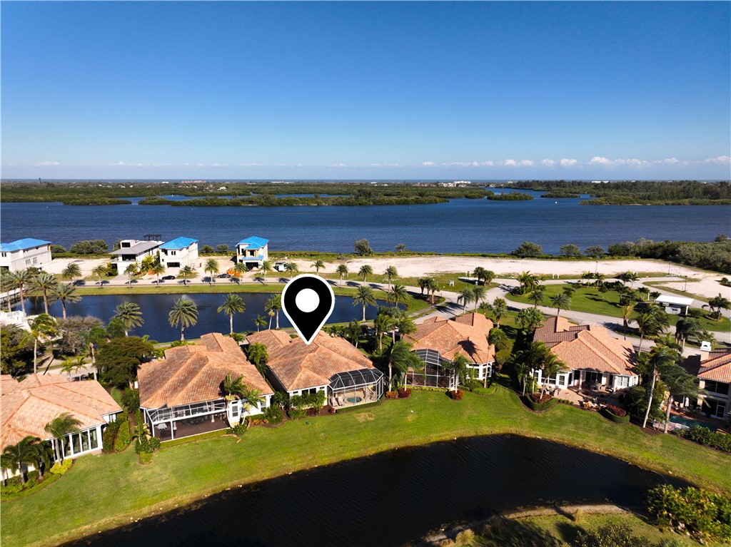 an aerial view of a house with a garden and lake view