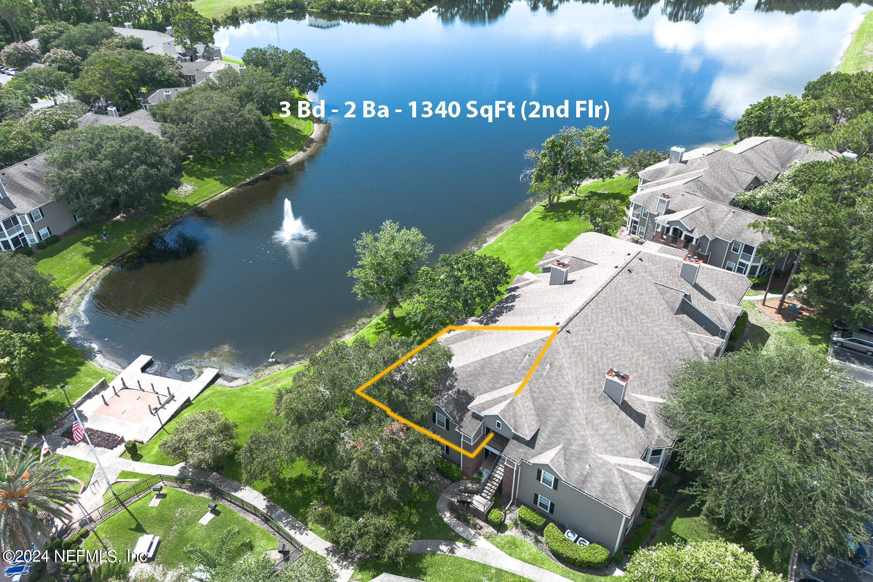 an aerial view of a house with a yard and lake view