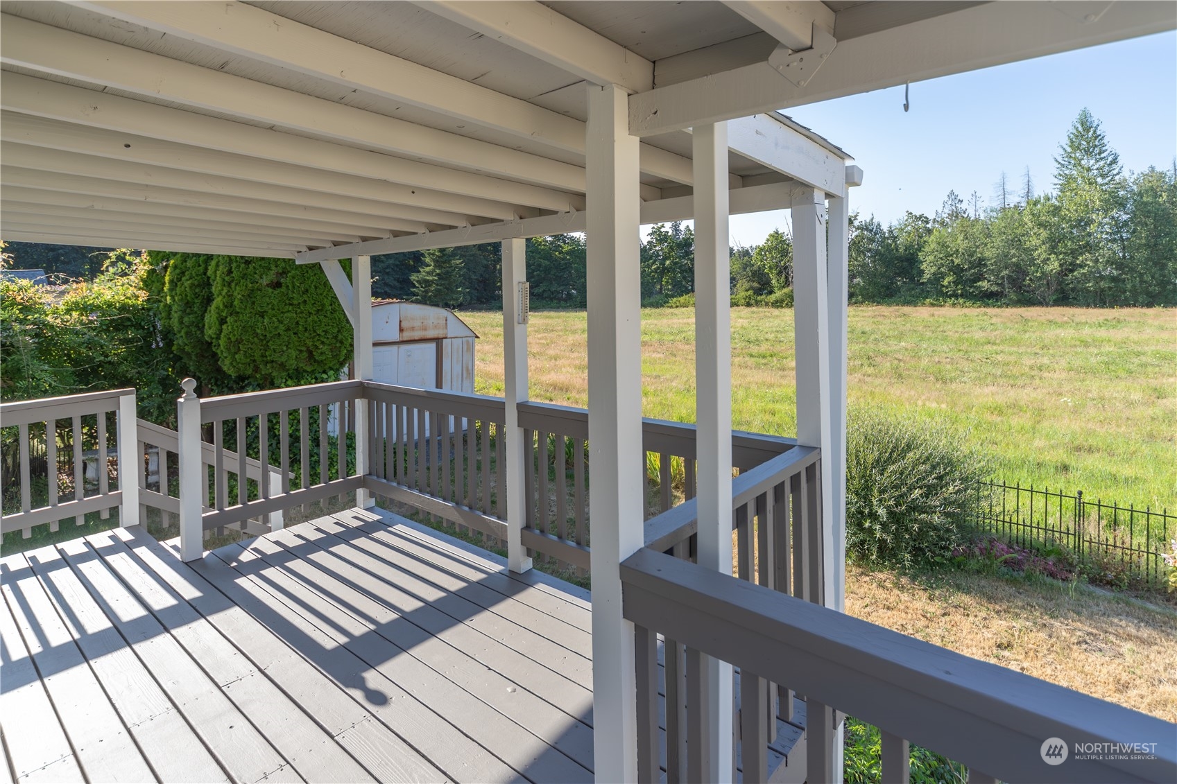 a view of a balcony with lake view and wooden floor