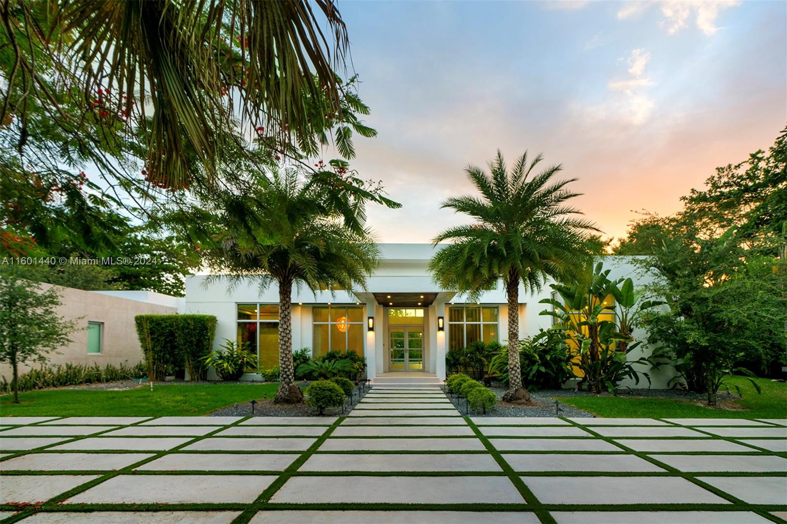 a front view of a house with a garden