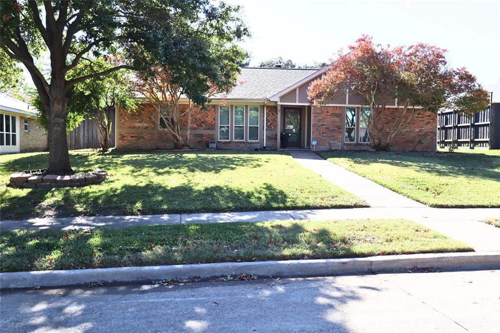 Single story home featuring a front yard