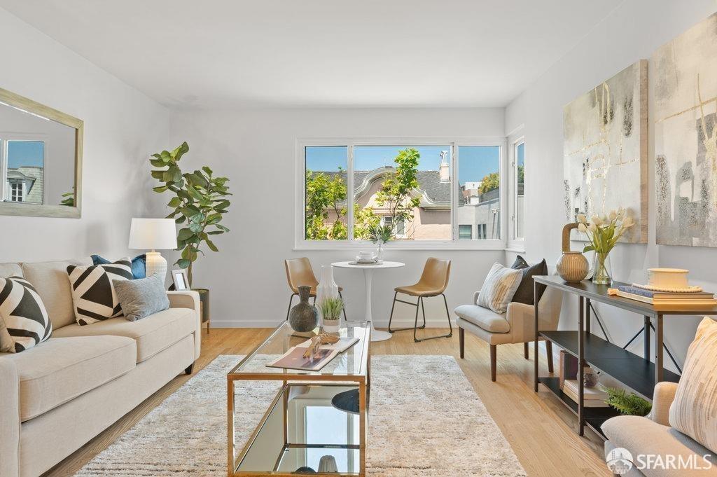 a living room with furniture and a potted plant