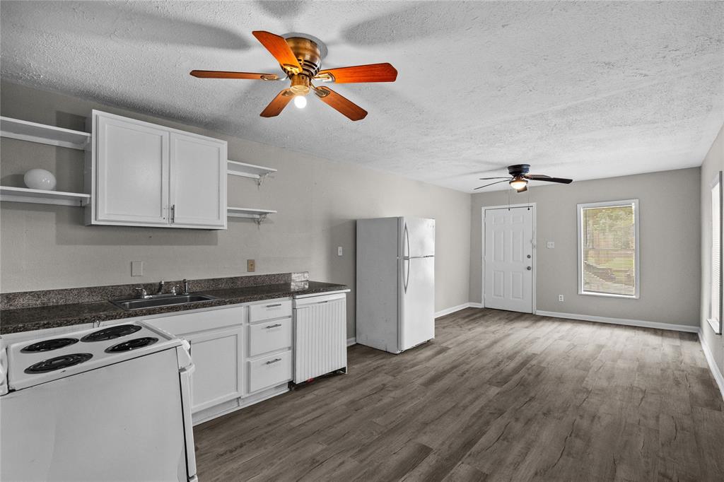 a kitchen with stainless steel appliances granite countertop a stove and a white cabinets