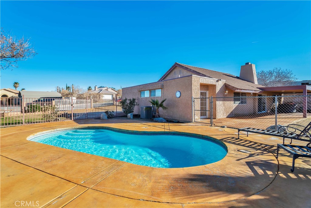 a view of a swimming pool with lounge chairs