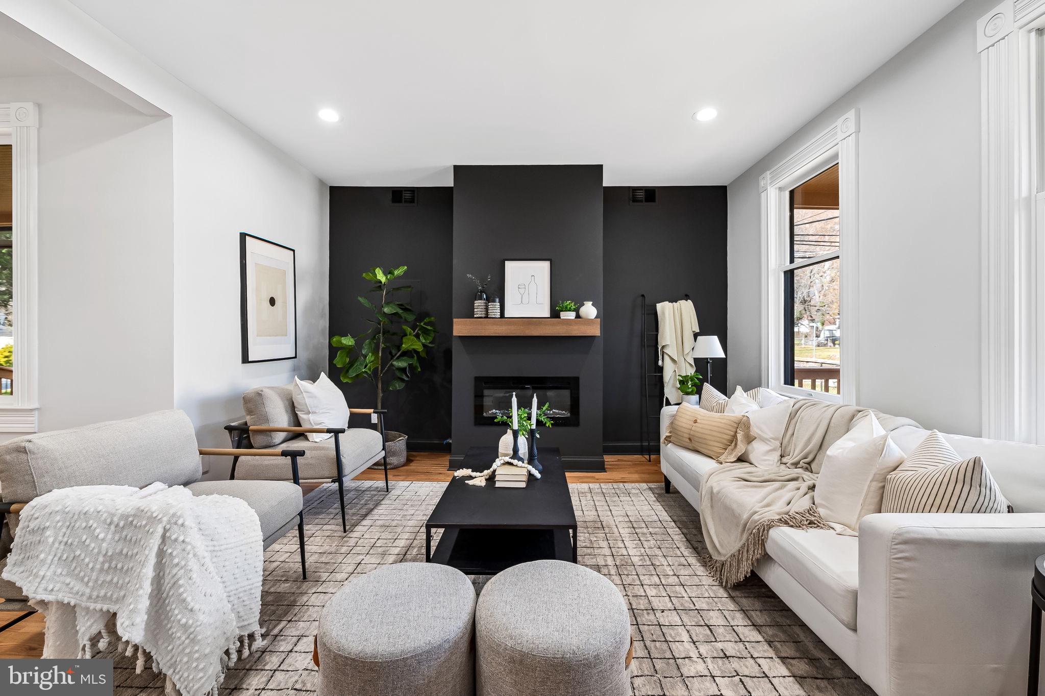 a living room with furniture fireplace and window