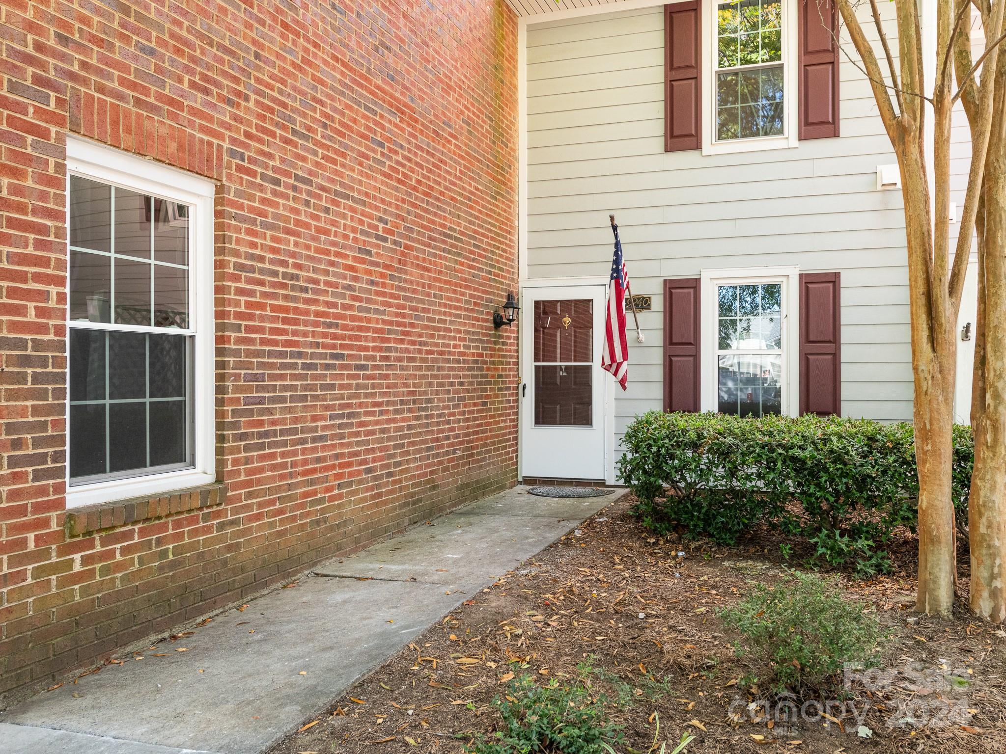 a view of a brick house with many windows