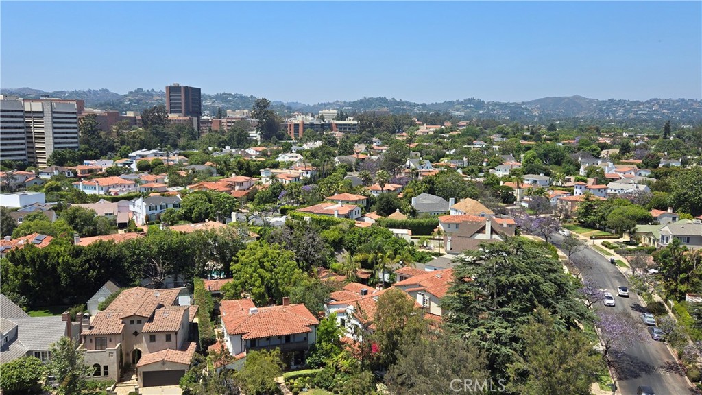 an aerial view of residential houses with city view