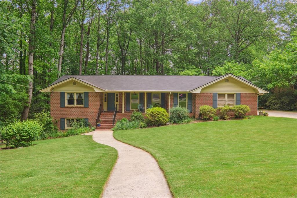 a front view of a house with garden