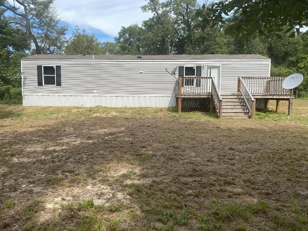 a view of a house with a backyard