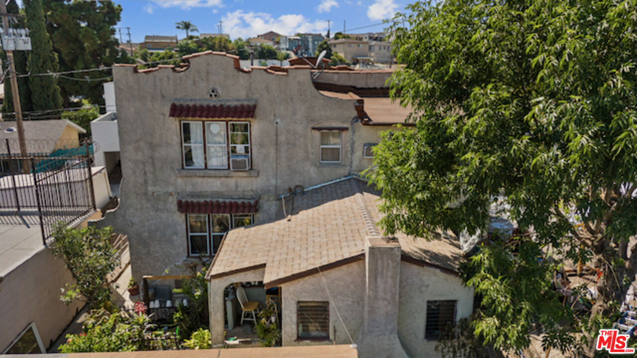 an aerial view of a house with a yard and tree s