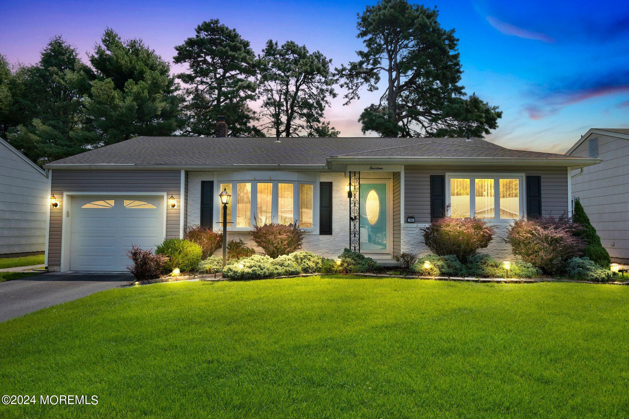 a front view of a house with yard and outdoor seating