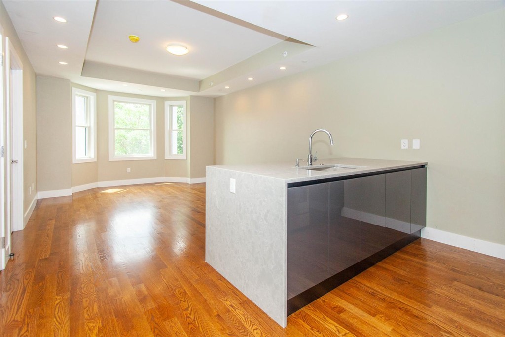 a view of a kitchen cabinets a sink and wooden floor