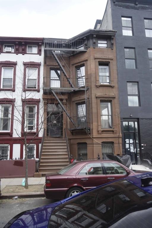 a front view of a house with street view